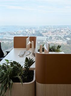 an office with a view of the city from it's desks and chairs