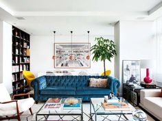 a living room filled with furniture and a potted plant on top of a table