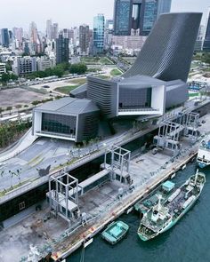 an aerial view of a boat dock in front of a large building with many windows