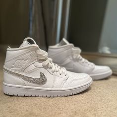 Custom Mid Jordan 1’s With Beautiful Crystals On The Nike Swoop. Great For Bride During Or After Ceremony, Wedding Party, Bachelorette Or Any Time You Need Some Extra Bling! Going For Much More On Sites Like Etsy! Quinceanera Sneakers, Dream Sneakers, Mid Jordan 1, Jordan White, Jordan 1s, Beautiful Crystals, Womens Jordans, Party Bachelorette, Ceremony Wedding