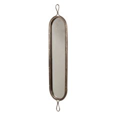 a mirror hanging from the side of a metal wall mounted hook on a white background