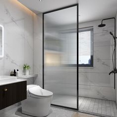 a bathroom with a toilet, sink and shower stall in white marbled tile walls