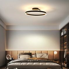 a bedroom with a large bed and two lamps on the wall above it's headboard