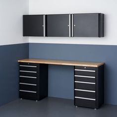 an office desk with drawers and cabinets on the wall next to each other in a room