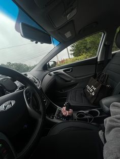 the interior of a car with steering wheel, dashboard and other items on it's dash board