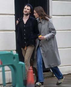 a man and woman walking down the street