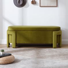 a green bench sitting in the middle of a living room