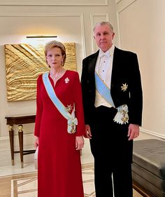 a man and woman in formal wear standing next to each other