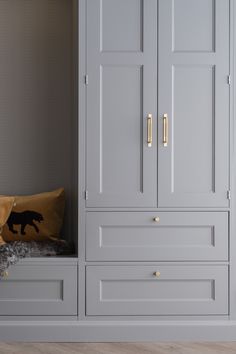 a room with gray cupboards and yellow pillows