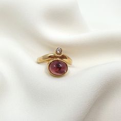 Delicate Art Nouveau ring made of 585 rose gold (14 kt) with incorporated rubellite cut into cabochon and a brilliant 0.09 ct. Inspired by historical templates, this impressive ring shows a high degree of genuine craftsmanship. The oval rubellite in 9x7 mm is cut into cabochon and is the centerpiece of this elegant ring. The integrated sparkling diamond creates a harmonious interaction. Worked in real 585 yellow gold (14 kt). An absolute eye-catcher. The ring is the perfect complement to the off Art Nouveau Ring, Unusual Art, Elegant Ring, Multi Stone Ring, Jewelry Case, Multi Stone, Sparkle Diamonds, Stone Rings, Or Rose