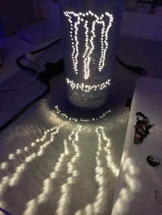 a lit up jar sitting on top of a table