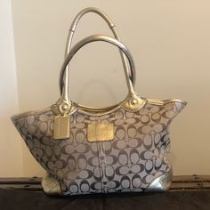 Beautiful And Functional Coach Bag. Great Condition With A Tint Bit Of Wear/ Discoloration On Underside Of Handles. Leather Trim And Handles. Large Outer Pocket At Back. Zip Top, Two Open Interior Pockets And One Additional Interior Zip Pocket. Checkered Logo Material On Inside. Dust Bag Included. 12.5” Across Bottom, 17.5” Across Top. 9” High And 9” Strap Drop. Brown Coach Purse, Coach Tote Bag, Coach Tote Bags, Coach Tote, Bags Coach, Croc Leather, Logo Material, Leather Handbags Tote, Coach Bag