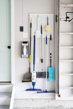 several cleaning tools are hanging on the wall