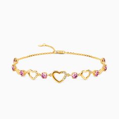 a gold bracelet with hearts and pink stones