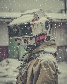 a man with a camera on his head in the snow