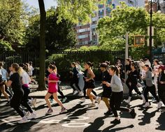 a group of people are running in the street