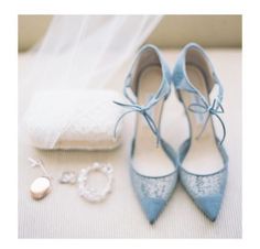 a pair of blue shoes next to a wedding ring