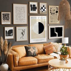 a living room filled with lots of pictures on the wall above a couch and coffee table