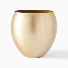 a gold vase sitting on top of a white table