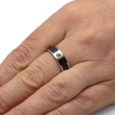 Wear your passion for vintage audio with this vinyl record ring! Polished titanium protects the the LP inlay. You're welcome to provide your own record for your wedding band, or use one from our own supply instead. This musical jewelry is perfect for audiophiles! RING LAYOUTRing Width: 6mmRing Sleeve: TitaniumRing Profile: FlatRing Finish: Polished 1mm Titanium4mm Partial Vinyl LP Record (x2)1mm Titanium Topaz (Qty: 1)Shape/Size: Round, 2.5 mmQuality/Color: AA, TealSetting: Full Bezel, 14k White Gold Vinyl Record Wedding, Record Wedding, Musical Jewelry, Unique Ring, Ring Sizer, Topaz Gemstone, Vinyl Lp, Jewelry Store, Vinyl Record