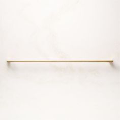 a white wall with a gold handle on it