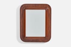 a wooden frame mirror mounted on the wall with a white back ground and light wood trim around it