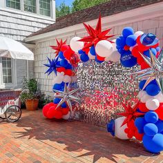 red, white and blue balloons in the shape of stars are on display at a party