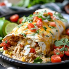 an enchilada on a plate with tomatoes and cilantro