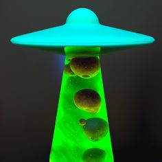 an alien like object is lit up in the dark