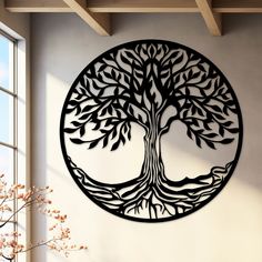 a metal wall hanging with a tree on it