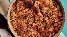 a pan filled with rice and meat on top of a table