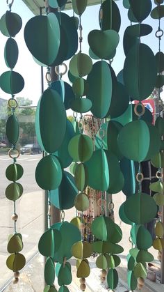 a group of green objects hanging from the side of a building