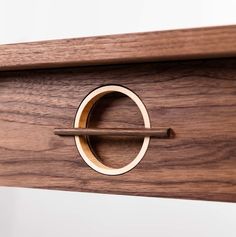 a close up of a piece of wood with a ring on it