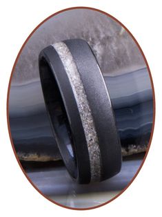 a wedding band that has been made with black ceramic and silver glitter