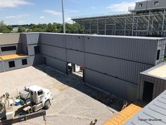 an overhead view of a building with two trucks parked in front