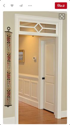 an open door leading to another room with wood floors and white trim on the walls