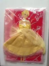 a barbie doll is packaged in plastic