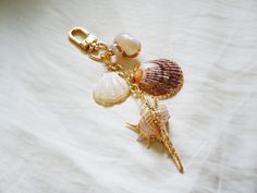 two seashells on a gold plated keychain with pearls and beads