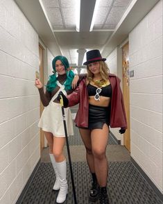 two women dressed in costumes are walking down the hallway together and one is holding a cane