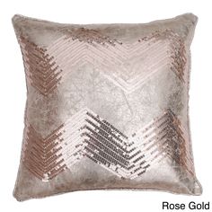 a silver and gold pillow with a diamond pattern on the front, sitting on a white background