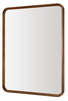 a wooden frame mirror hanging on the wall with a white back ground and brown trim