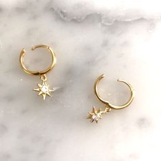 Adorable And On-Trend Hinge Huggie Hoops With Cz Starburst Charm. 16k Gold Plating Over 925 Sterling Silver. 12mm Hoop. Hoop Earrings With Charm, Harper Row, Huggie Hoop Earrings, Dream Jewelry, Ladies Boutique, Inspirational Women, Gold Plating, Gold Plate, Hoop Earrings