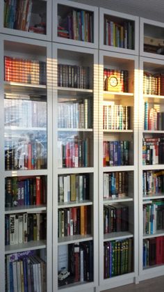 the bookshelves are filled with many different colored books