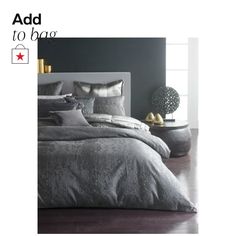 a bed with grey sheets and pillows on the bottom is advertised for $ 599 00