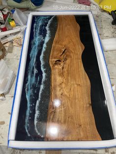 a wooden table with blue and black paint on it