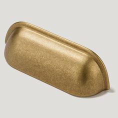 a gold metal object on a white background