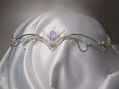 Average delivery terms USA, France, Ireland - 3-4 weeks Australia, Canada - 4-6 weeks Netherlands, Spain - 2-3 weeks Wire wrapped tiara made of silverplated copper wire and Czech glass beads. The piece is covered by metal protecting lacquer. The tiara fits any head size. It has two cords made of metallic embroidery floss on  it's sides and a slide bead to adjust the tiara to the size you need. Another metal (copper, brass) or beads are also possible if you prefer to make some changes to the desi Metallic Embroidery