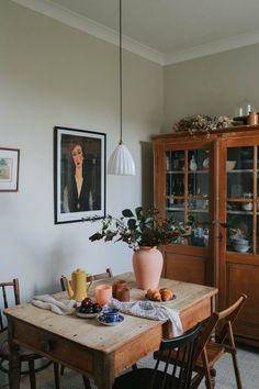 a dining room table with plates and cups on it