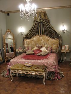 a fancy bed with pink and gold decor