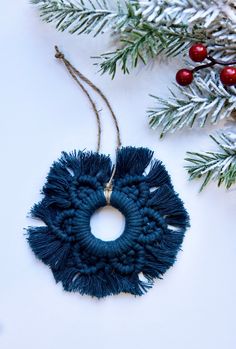 a blue ornament hanging from a christmas tree